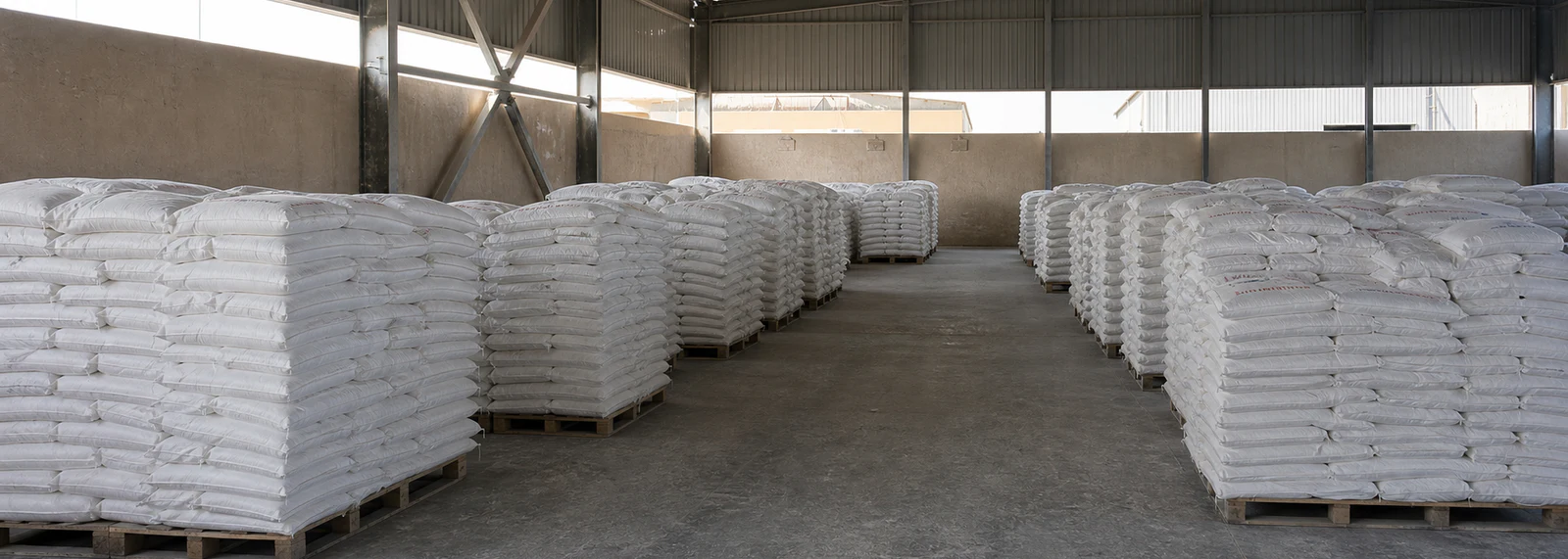 Palletised 25 kg calcium carbonate bags stored in the finished-goods warehouse at our plant